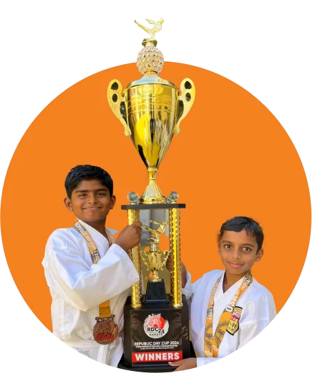 Two diverse students holding a large golden trophy, with school building background, within an orange circle.